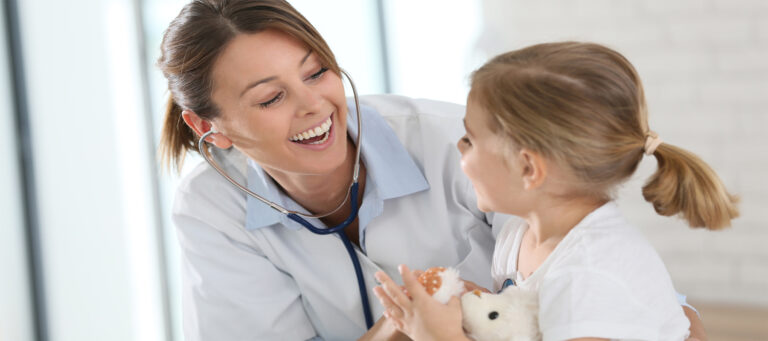 Pediatrician with child in doctors office